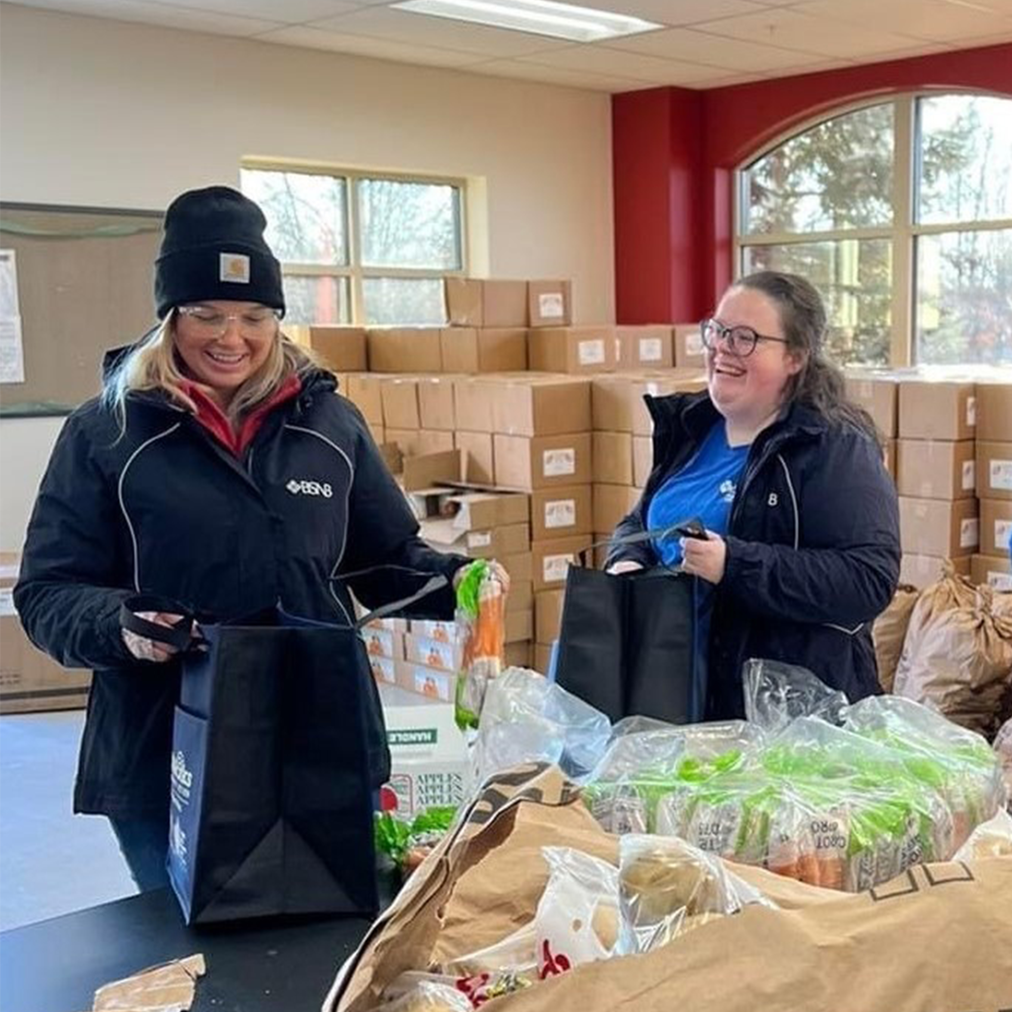 BSNB employee loading food into customer's car trunk